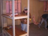 John Oliver takes measurements for the floor layout plan.